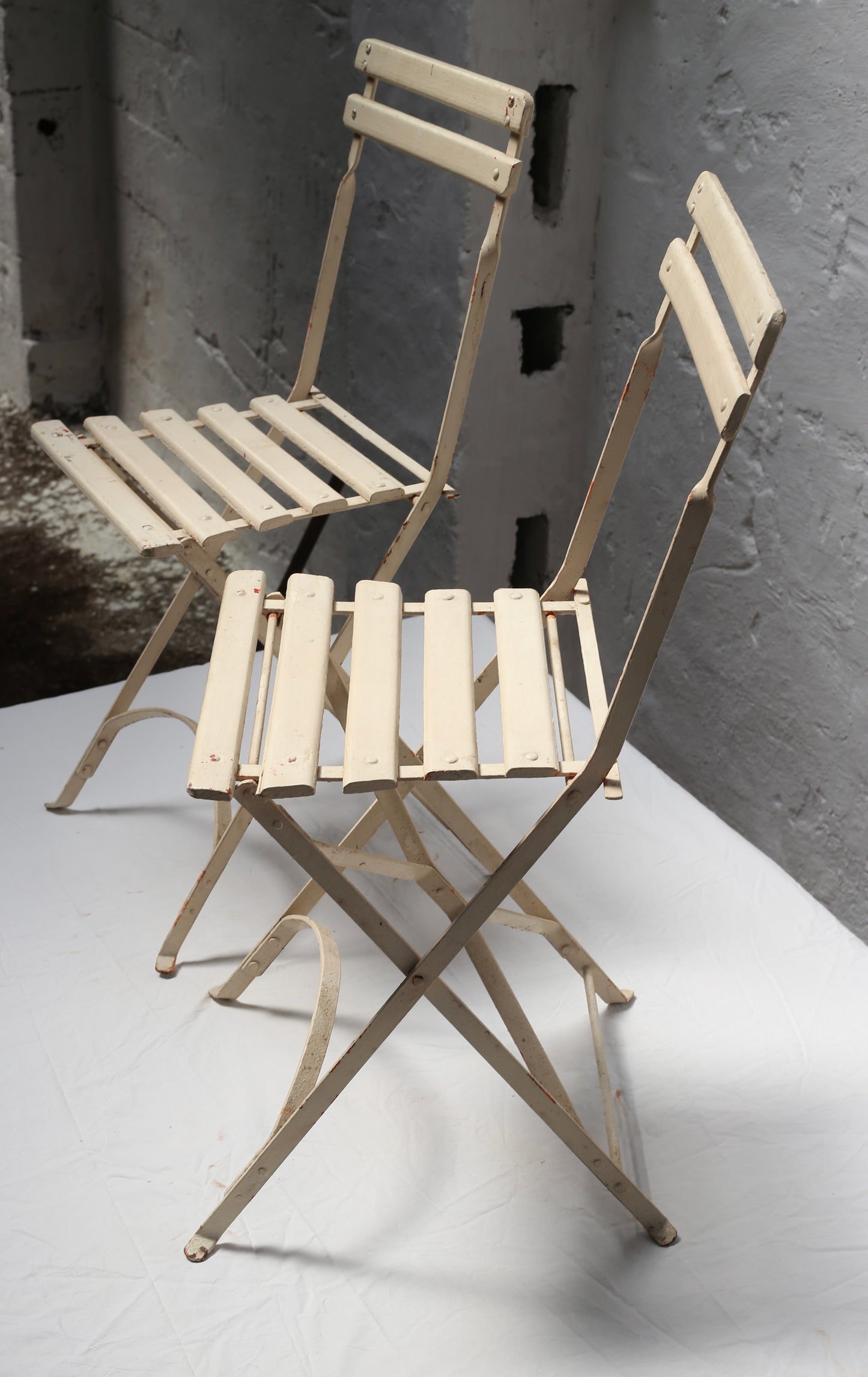 Pair of folding, 19th century garden chairs, in cream.